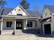 Charming new construction home featuring a covered entryway and yellow and white siding accents at 3945 Bulow Landing Rd, Hollywood, SC 29470