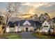 Stunning home boasts a large yard, classic white exterior, and a paved driveway leading to the entrance at 3945 Bulow Landing Rd, Hollywood, SC 29470