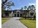 Stunning home boasts a lush yard, classic white exterior, and a paved driveway leading to the entrance at 3945 Bulow Landing Rd, Hollywood, SC 29470