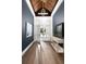 Bright foyer with hardwood floors, striking wood ceiling, and stylish chandelier at 3945 Bulow Landing Rd, Hollywood, SC 29470