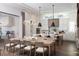 Open-concept kitchen with an island, seating, and modern lighting adjacent to the dining area at 3945 Bulow Landing Rd, Hollywood, SC 29470