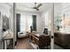 Bright office space with wood floors, shutters, stylish ceiling fan, and a charming desk at 3945 Bulow Landing Rd, Hollywood, SC 29470