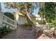 Brick patio with seating surrounded by lush landscaping and mature trees at 102 Barnaby St, Charleston, SC 29492