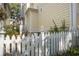 Charming backyard featuring a white picket fence, beautiful garden, and colorful plants at 102 Barnaby St, Charleston, SC 29492