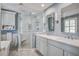 Light-filled bathroom features a modern glass shower, a double sink vanity and a soaking tub at 102 Barnaby St, Charleston, SC 29492