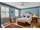 Bright bedroom featuring natural light from window with shutters, hardwood floors and floral wallpaper at 102 Barnaby St, Charleston, SC 29492