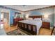 Bright bedroom with a ceiling fan, light blue walls, hardwood floors, and natural light at 102 Barnaby St, Charleston, SC 29492