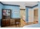 Comfortable bedroom featuring desk and bookcase with easy access to the ensuite bathroom and hallway at 102 Barnaby St, Charleston, SC 29492