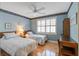 Bright bedroom with hardwood floors, ceiling fan, a window with shutters, and two comfortable twin beds at 102 Barnaby St, Charleston, SC 29492