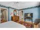 Bright bedroom featuring natural light, hardwood floors, floral wallpaper, and an ensuite bathroom at 102 Barnaby St, Charleston, SC 29492