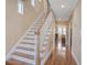 Foyer featuring hardwood floors, paneled staircase, and natural light at 102 Barnaby St, Charleston, SC 29492