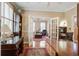 Elegant home office featuring beautiful hardwood floors, custom desk, and french doors at 102 Barnaby St, Charleston, SC 29492