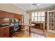 Well-lit home office with a large desk, custom cabinetry, and lots of storage space at 102 Barnaby St, Charleston, SC 29492