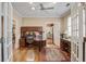 Spacious home office featuring custom built-ins, wood floors, and lots of natural light at 102 Barnaby St, Charleston, SC 29492