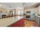 Open floor plan from the kitchen into the living area featuring a fireplace and outdoor views at 102 Barnaby St, Charleston, SC 29492