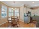 Bright kitchen featuring stainless steel appliances and a dining table under large windows at 102 Barnaby St, Charleston, SC 29492