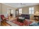 Inviting living room with hardwood floors, comfortable seating, and a classic display cabinet, offering a cozy ambiance at 102 Barnaby St, Charleston, SC 29492