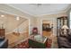 Spacious living room with hardwood floors, elegant furniture, and a seamless transition to a home office at 102 Barnaby St, Charleston, SC 29492