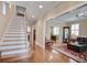 Spacious foyer leads into an elegant living room with hardwood floors and staircase at 102 Barnaby St, Charleston, SC 29492