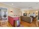 Open-concept living area with hardwood floors, a kitchen island, and cozy seating at 102 Barnaby St, Charleston, SC 29492