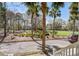 Scenic view from porch overlooking a beautifully landscaped park with mature trees and charming neighborhood homes at 102 Barnaby St, Charleston, SC 29492