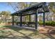 Community pavilion with picnic tables for gatherings, surrounded by lush greenery and shade trees at 102 Barnaby St, Charleston, SC 29492
