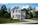 Charming two-story home featuring a welcoming front porch, a two-car garage and a well-manicured lawn at 102 Snow St, Summerville, SC 29486