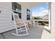 Relaxing front porch features a sitting area with rocking chairs and bright sunlight at 102 Snow St, Summerville, SC 29486