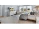 Bright bedroom boasting a dresser, chair, many windows, and a comfortable bed with stylish bedding at 1049 Tea Time Dr, Summerville, SC 29485
