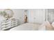 Bright bedroom with a dresser, decorative mirror, view to an open doorway, and neutral tones at 1049 Tea Time Dr, Summerville, SC 29485