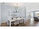 Dining room with a chandelier, table set for six, and views of the adjacent living spaces at 1049 Tea Time Dr, Summerville, SC 29485