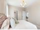 This inviting bedroom features patterned wallpaper, white linens, and neutral toned accents with an ensuite bathroom at 109 Marions Oak Dr, Summerville, SC 29486