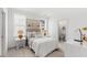 Bright bedroom with nautical decor, white shiplap walls, and an ensuite bathroom, creating a cozy and stylish retreat at 109 Marions Oak Dr, Summerville, SC 29486
