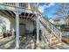Back patio with stone pavers, stairs to deck, and outdoor storage at 109 White Pine Way, Summerville, SC 29485