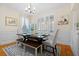 Bright dining room with stylish chandelier, plantation shutters, and hardwood floors at 109 White Pine Way, Summerville, SC 29485
