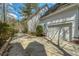 Side of home, featuring a clean garage, long drive way, and manicured lawn at 109 White Pine Way, Summerville, SC 29485