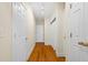 Bright hallway with wooden floors and multiple white doors providing access to rooms at 109 White Pine Way, Summerville, SC 29485
