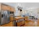 Bright kitchen with wooden cabinets, stainless steel appliances, island, and breakfast nook at 109 White Pine Way, Summerville, SC 29485