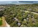 Expansive aerial view of a community surrounded by lush trees, a golf course, and a coastal shoreline at 1121 Summer Wind Ln, Seabrook Island, SC 29455
