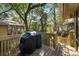 Outdoor back deck featuring a wooden deck and railing, grill, and surrounding trees at 1121 Summer Wind Ln, Seabrook Island, SC 29455
