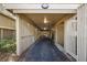 Long carport with unit number above the entrance featuring asphalt driveway and neutral tones at 1121 Summer Wind Ln, Seabrook Island, SC 29455