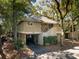 Lovely two-story home with covered parking and stairs, surrounded by lush, mature trees at 1121 Summer Wind Ln, Seabrook Island, SC 29455