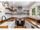 Charming kitchen featuring open shelving, stainless appliances, and wood countertops at 1121 Summer Wind Ln, Seabrook Island, SC 29455
