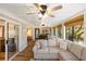 Relaxing sunroom features comfortable seating, wood floors, and sliding door to bedroom at 1121 Summer Wind Ln, Seabrook Island, SC 29455