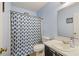 Simple bathroom featuring a vanity sink, toilet, and shower with blue patterned curtain at 114 Tennyson Way, Summerville, SC 29486