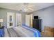 Comfortable bedroom with ceiling fan, large dresser, and view to ensuite bathroom at 114 Tennyson Way, Summerville, SC 29486