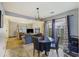 Open dining area with living room view, featuring a glass table with leather chairs and natural light at 114 Tennyson Way, Summerville, SC 29486