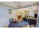 Bright dining area featuring a glass table, leather chairs, view to the open living space, and warm lighting at 114 Tennyson Way, Summerville, SC 29486