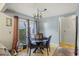 Cozy dining area featuring a glass-top table, leather chairs, and natural light from the sliding glass doors at 114 Tennyson Way, Summerville, SC 29486