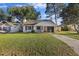 Charming single-story home with a well-manicured front yard, driveway, and attached garage at 114 Tennyson Way, Summerville, SC 29486